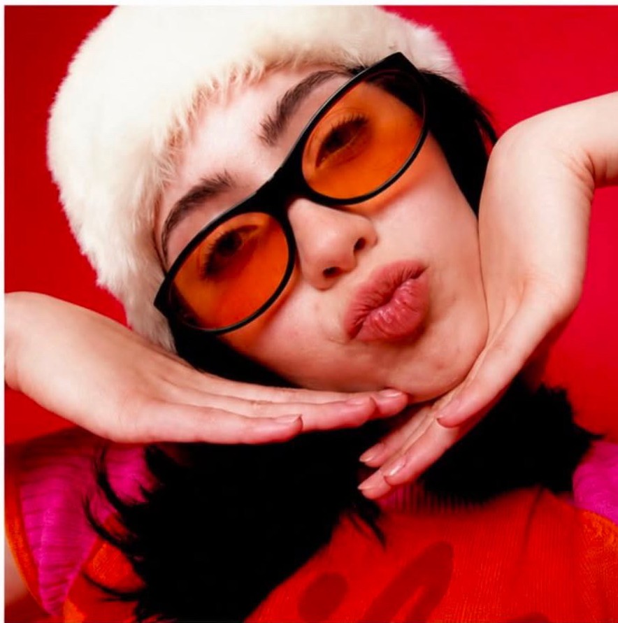 Lila B, female model, bold colour editorial portrait wearing tinted glasses